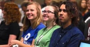 Students watching and smiling